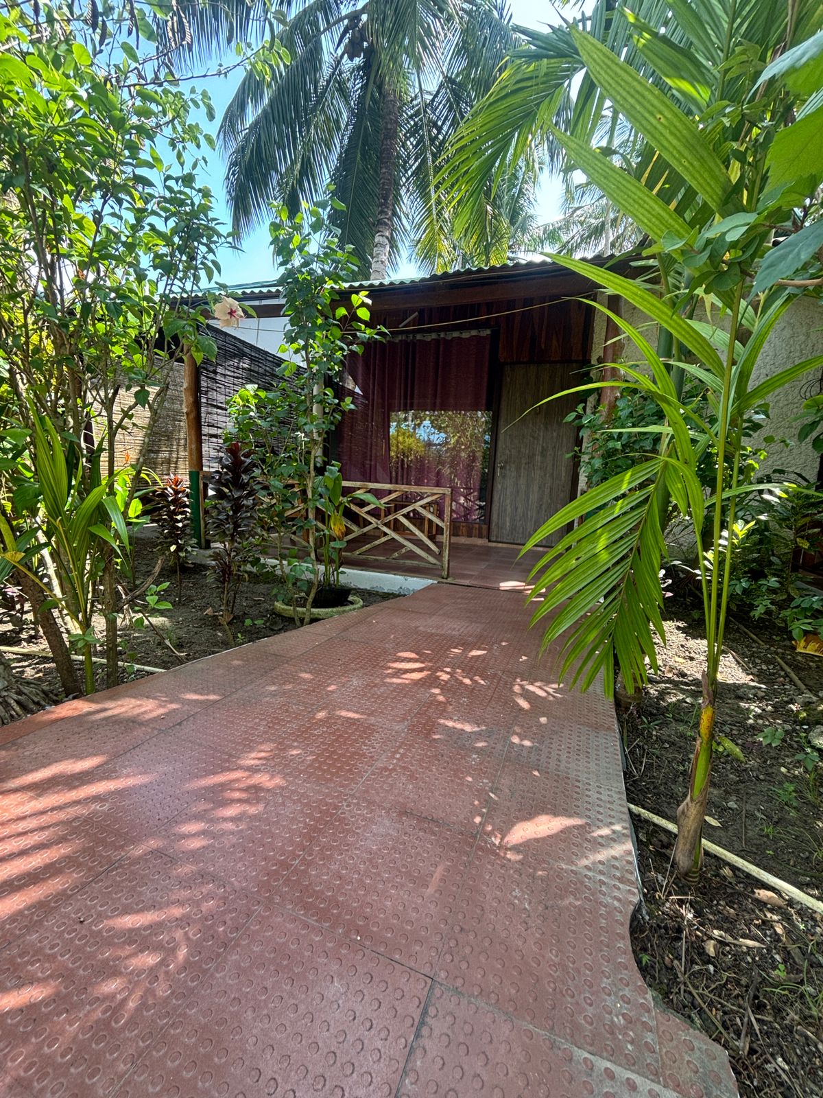 Garden-side cottage and shaded path at Placid Garden on the Govind Nagar lane in Havelock
